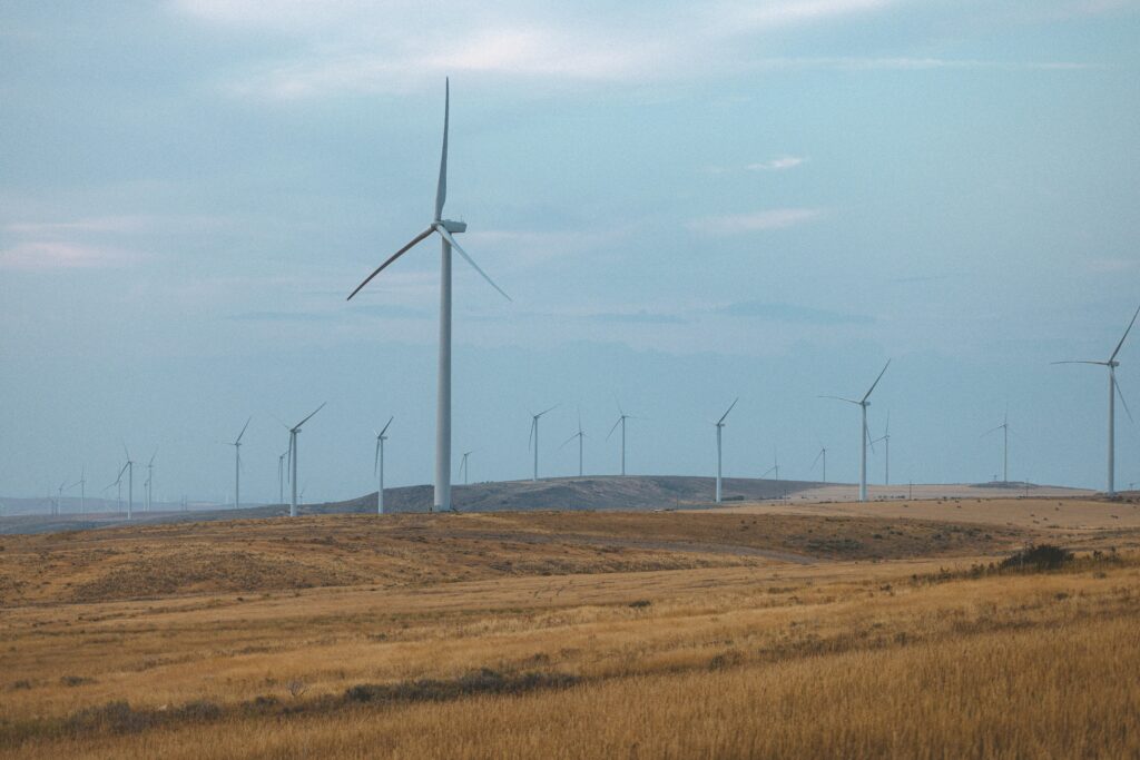 pexels-photo-13662284-13662284 Wide view of wind turbines in a rural setting harnessing wind energy for sustainable power.